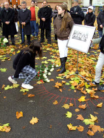 Kinder legen Rosen im Gedenken an die Schüler der Jüdischen Sonderklasse nieder