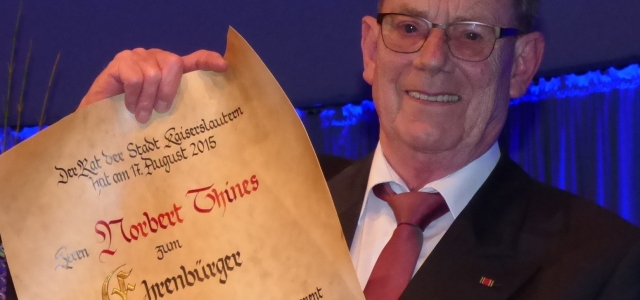 © Stadt Kaiserslautern Norbert Thines mit der Ehrenbürgerurkunde auf der Bühne der Fruchthalle am 27. Januar 2016.